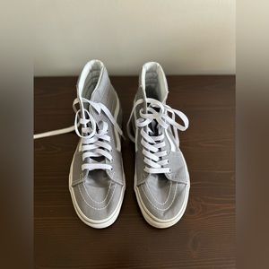 Woman’s grey high top vans
